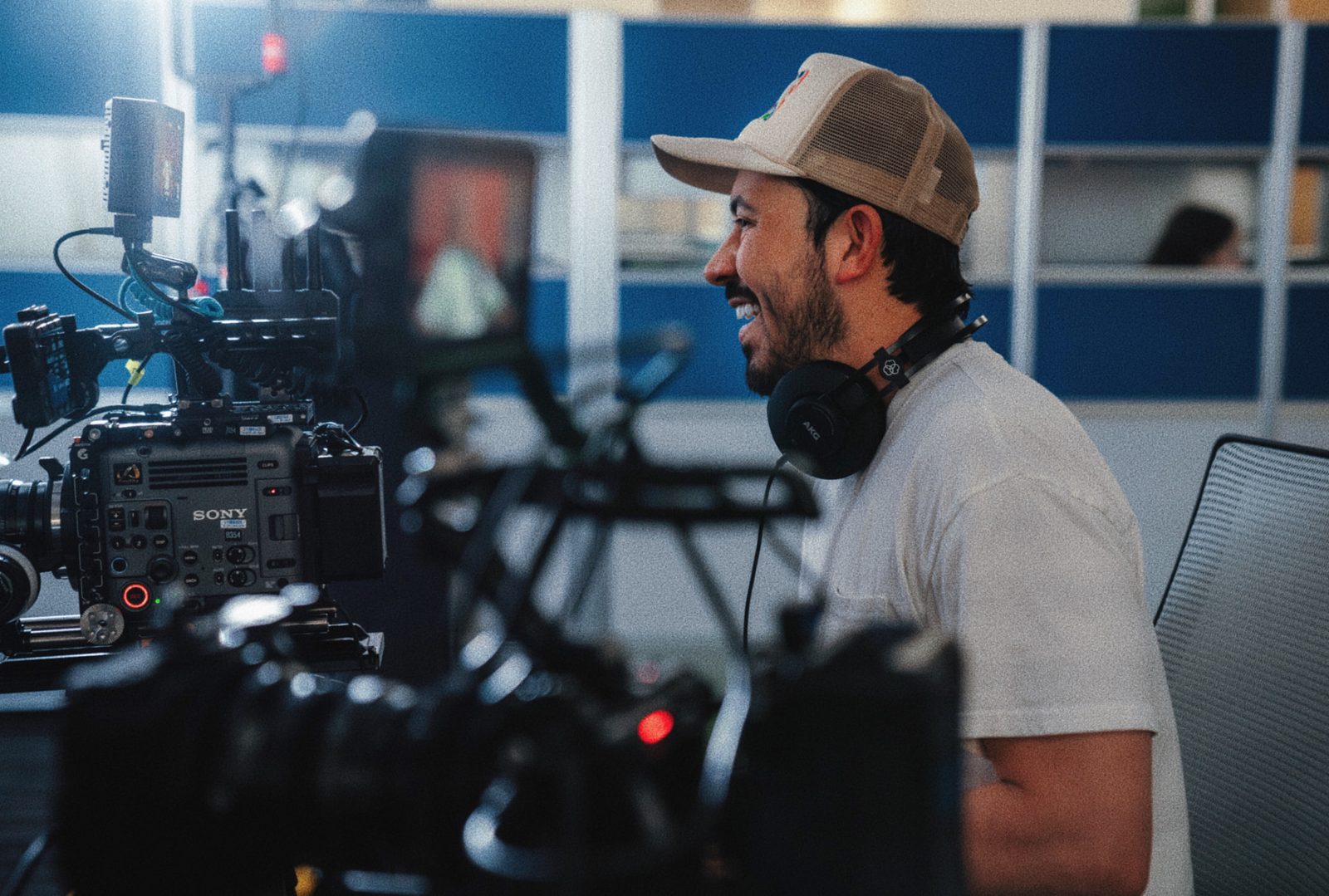 Director laughing behind a Sony cinema camera on a school set