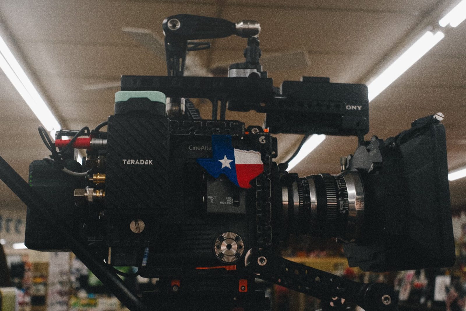 Cinema camera rig with a Texas flag plate on a retail set
