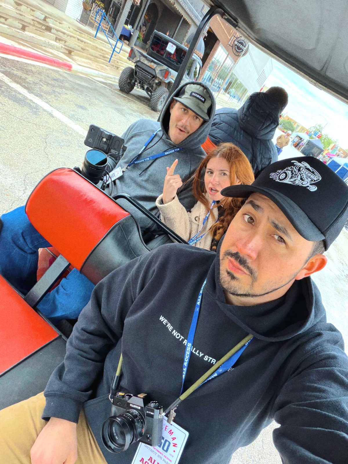 Crew riding between setups on a production cart